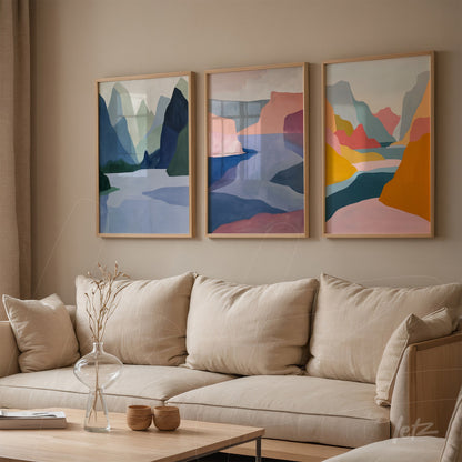 composition of three artworks featuring colorful abstractions of mountains and rivers in light wood frames displayed against a neutral wall