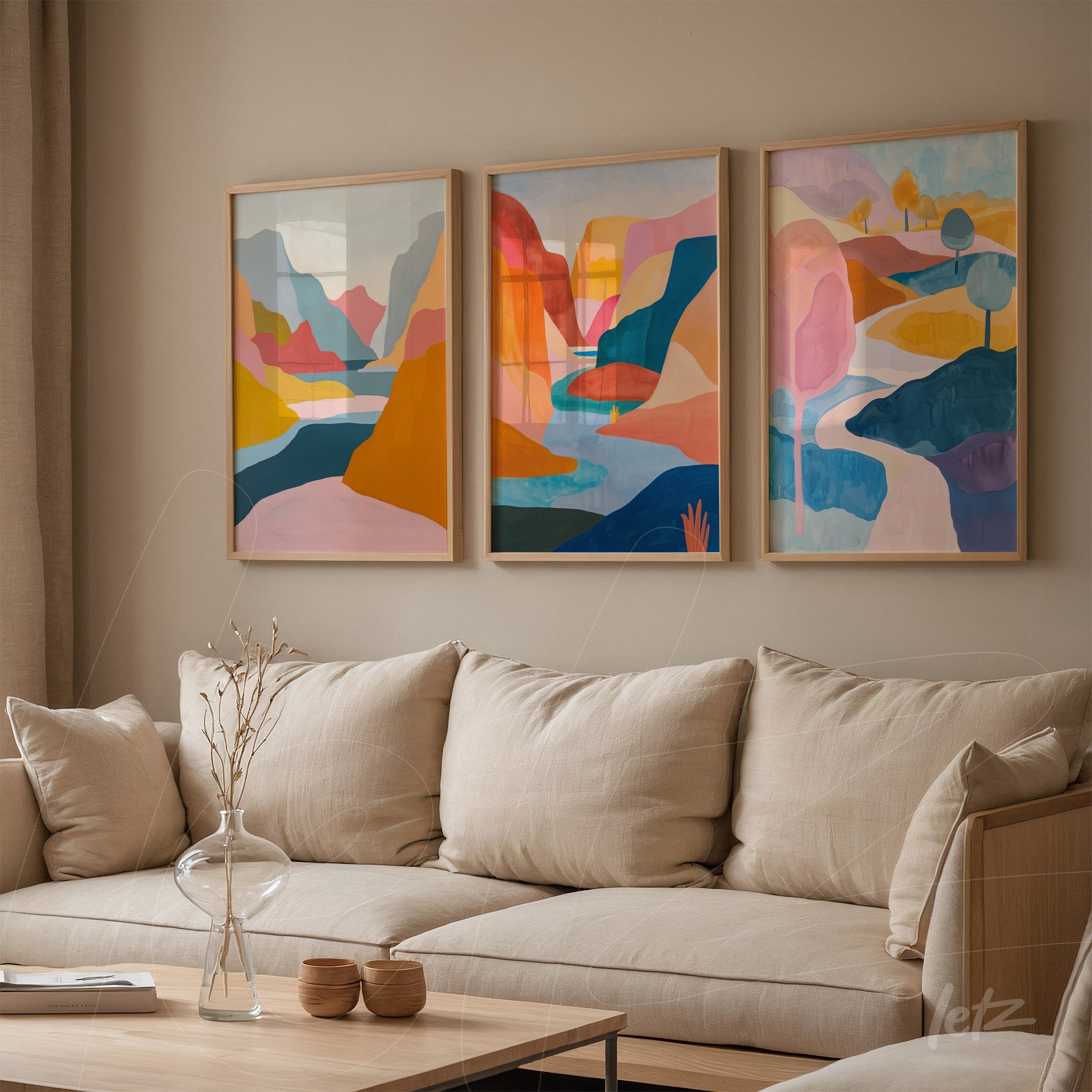 set of framed artworks featuring colorful abstract landscapes in light wood frames on beige wall
