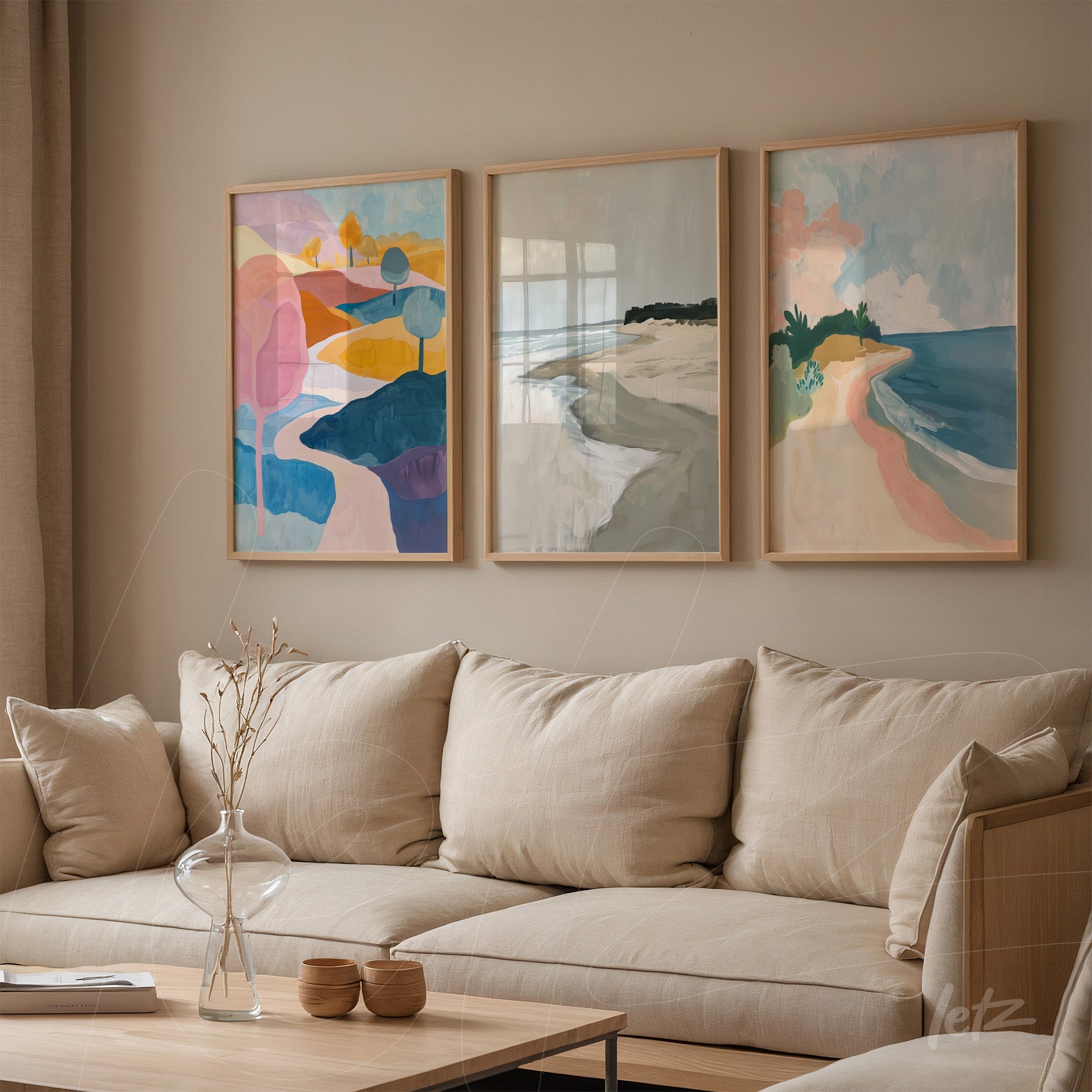 series of wall art featuring abstract landscapes in light wooden frames displayed on a neutral wall