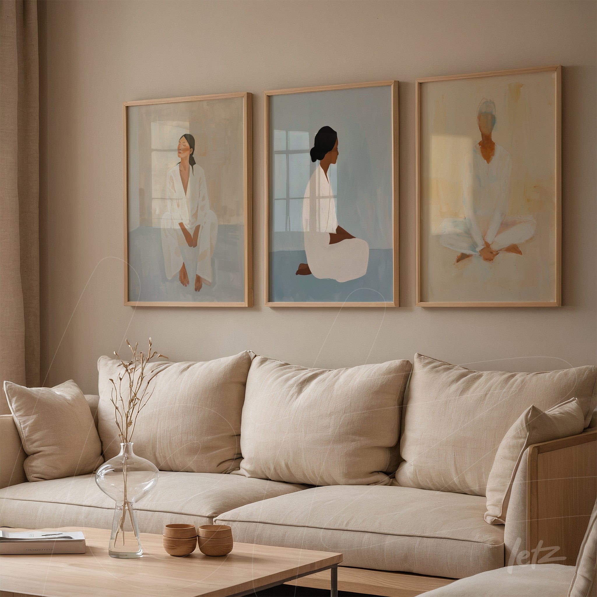 set of three framed artworks depicting women in a minimalist style with light wood frames displayed on a neutral wall next to a linen sofa