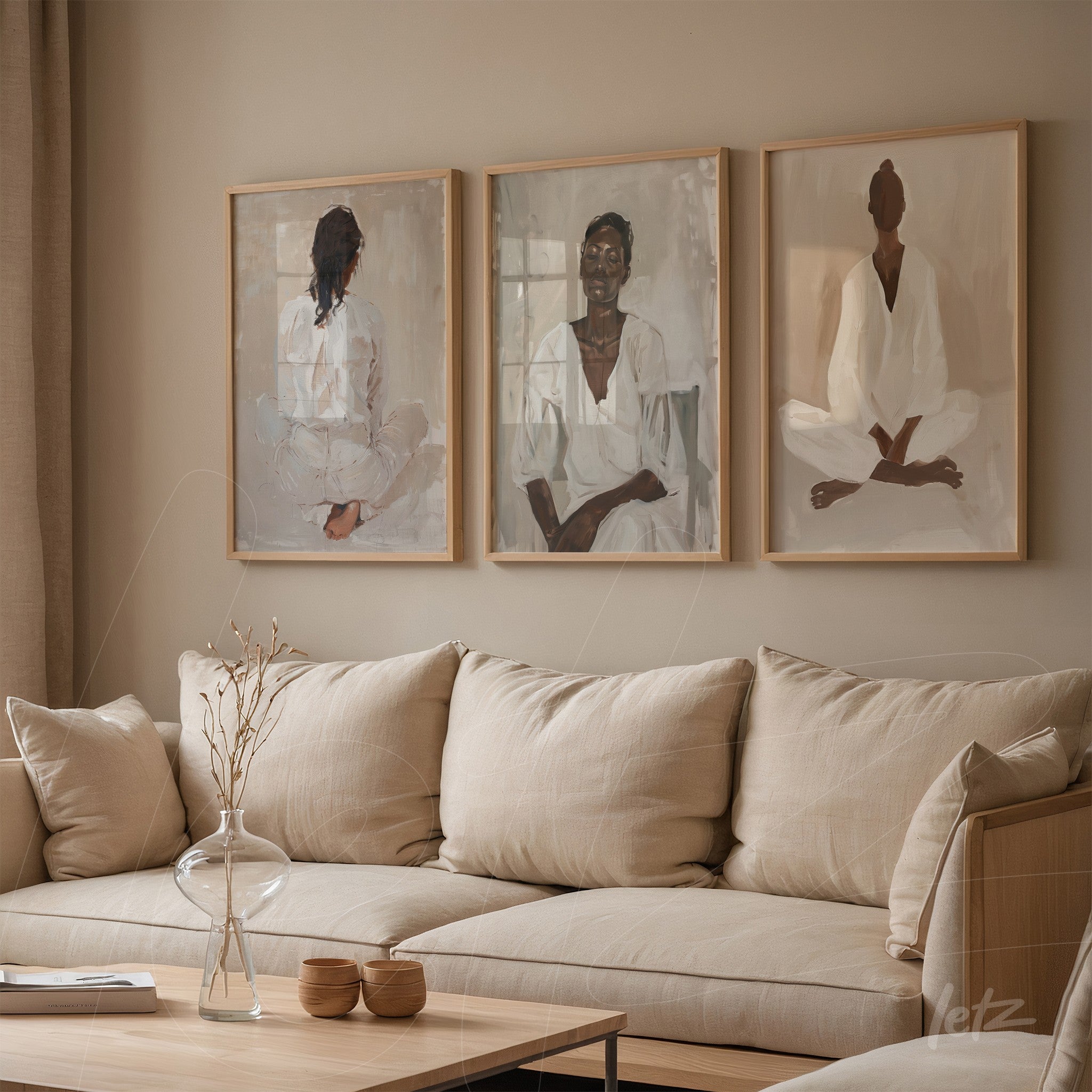 series of artworks depicting seated individuals in meditative poses, framed in light wood, displayed in a cozy living room with linen sofa