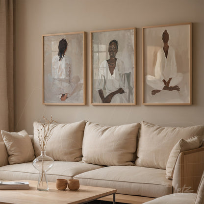 series of artworks depicting seated individuals in meditative poses, framed in light wood, displayed in a cozy living room with linen sofa