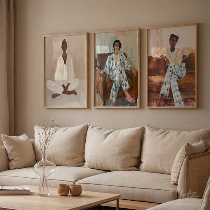 composition of three framed artworks in light wood depicting seated female figures in various outfits, displayed on a neutral tone wall