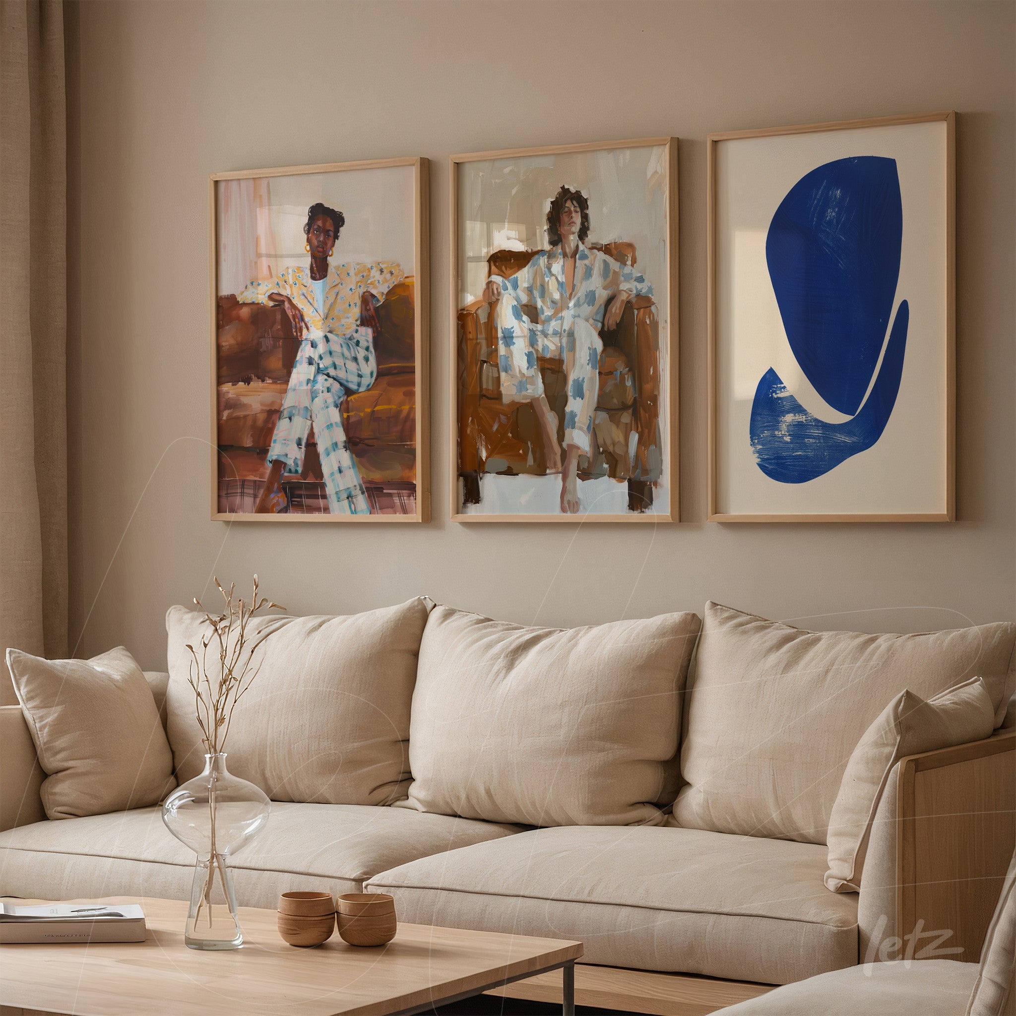 collection of three framed artworks displayed on a beige wall, featuring stylized female figures in blue and white outfits, one seated in an armchair and the other in a relaxed pose
