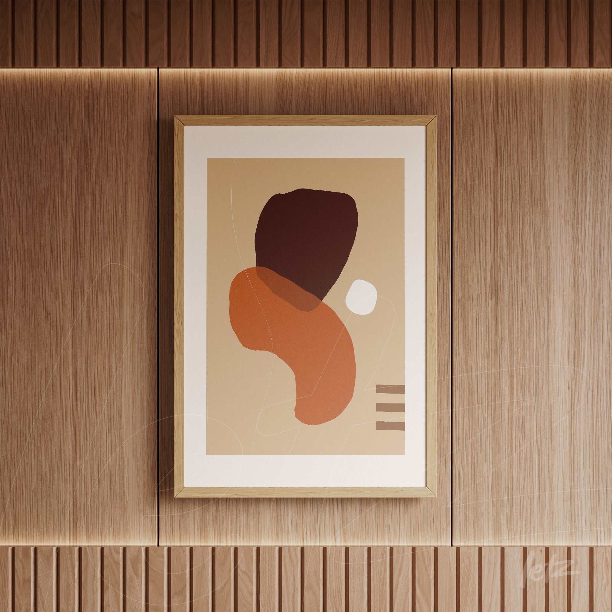 abstract art in light wood frame with organic shapes in earthy tones on wood-paneled wall
