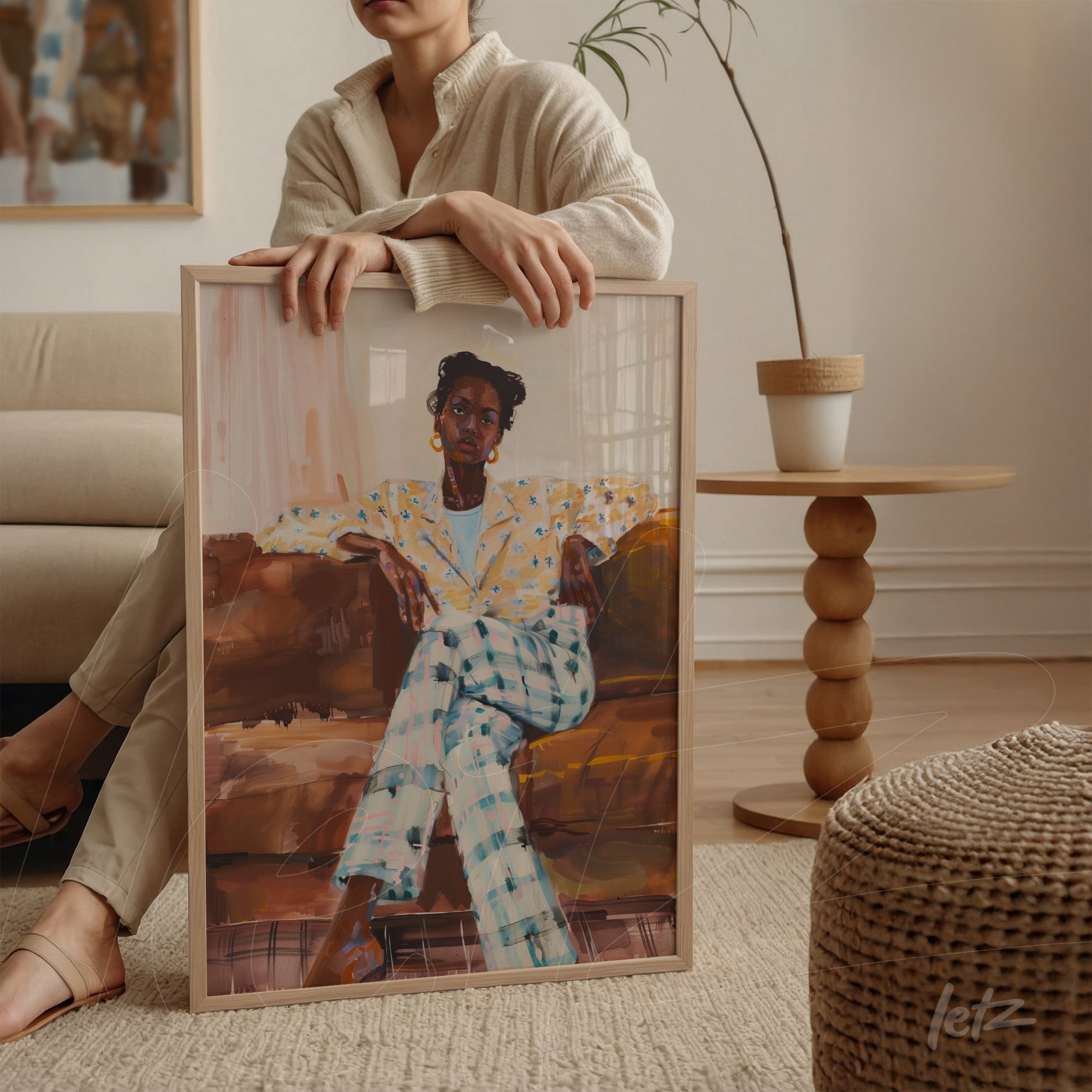 framed wall art featuring a portrait of a black woman wearing a polka dot top and checkered pants, displayed on a round table
