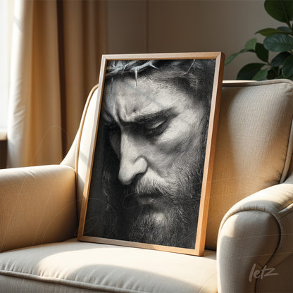framed wall art in light wood featuring a black and white portrait of a male figure with a crown of thorns in close-up