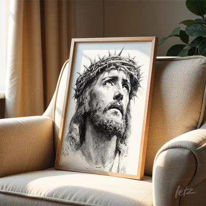 framed black and white portrait of jesus christ with clear wood frame resting on a beige sofa