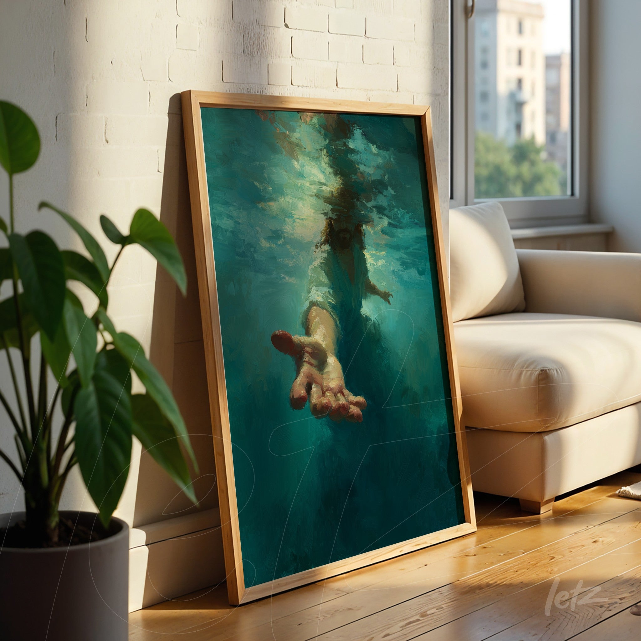 framed artwork of a hand emerging from water featuring a light wooden frame