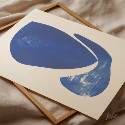 abstract wall art in shades of blue on light background, resting in a wooden frame