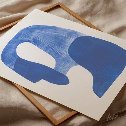 abstract wall art in deep blue on white background framed in light wood