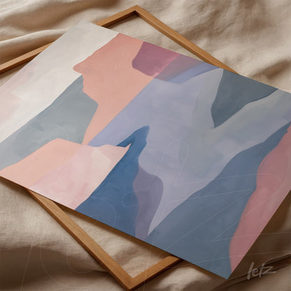 abstract wall art in shades of pink and blue, resting on natural fabric with light wood frame