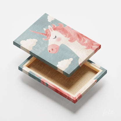 decorative box featuring unicorn design against a blue background with white clouds
