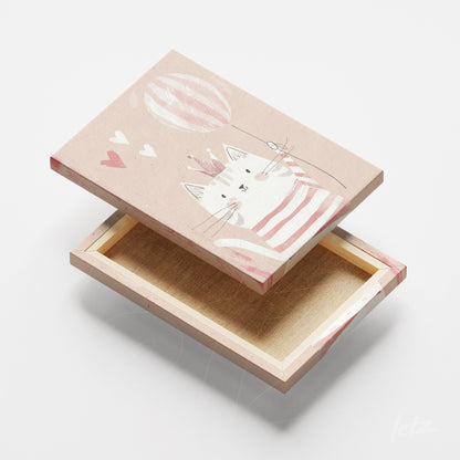canvas artwork featuring a cute cat in a striped shirt holding a balloon with a soft pink background