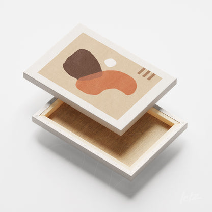 canvas with abstract art in earthy tones and organic shapes on a light surface