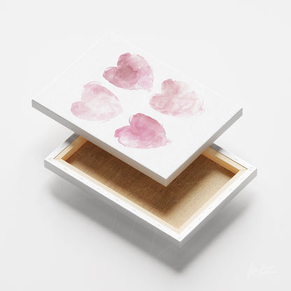 canvas art featuring watercolor hearts in pink shades on a white background