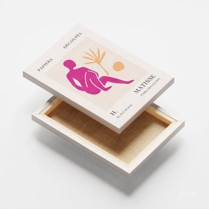 decorative box featuring cut-out art of foliage in vibrant colors with a neutral background and a stylized human figure