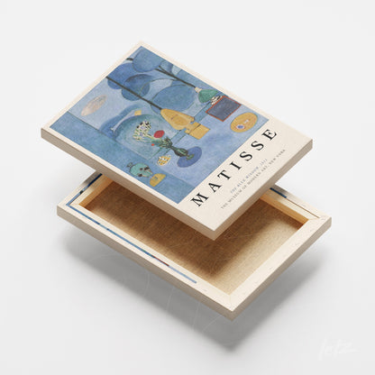 canvas artwork by Henri Matisse featuring a composition of blue and yellow shapes on a light background with natural frame