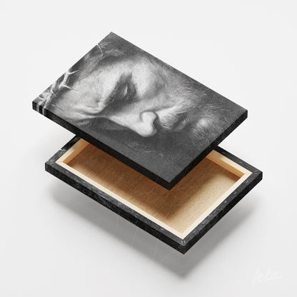 framed art featuring a black and white illustration of a male face with a thin black frame