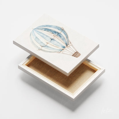 decorative box featuring a blue hot air balloon illustration on a light background