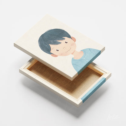 canvas print featuring an illustration of a boy with dark hair and blue shirt, light wood frame