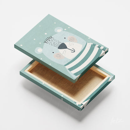 decorative box featuring a bear illustration in blue and green with white accents