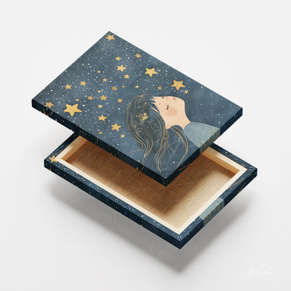 decorative box featuring illustration of a girl gazing at stars on dark blue background