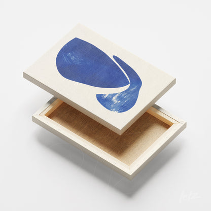 canvas featuring abstract blue art on light background with wooden frame