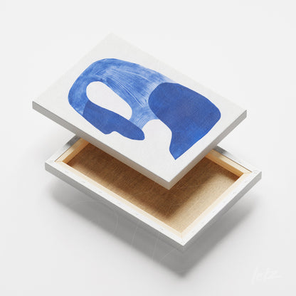 canvas wall art featuring abstract design in shades of blue on light background