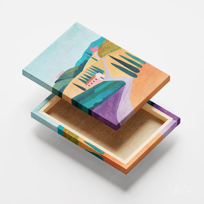 canvas art featuring an abstract colorful landscape with hills, cypress trees, and small houses in various shades