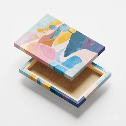 canvas print featuring abstract design in shades of pink, blue, and yellow displayed on white background