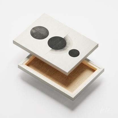canvas print featuring abstract black and white circles on a light background