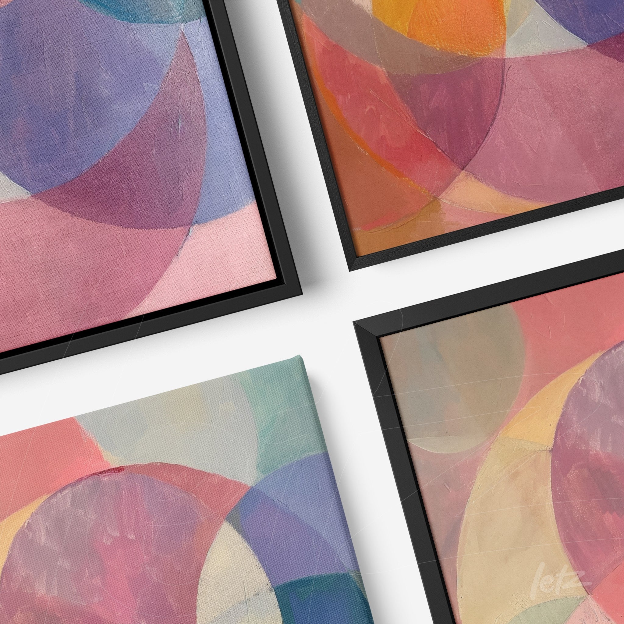 collection of framed abstract wall art featuring soft colors and black frames at an angle