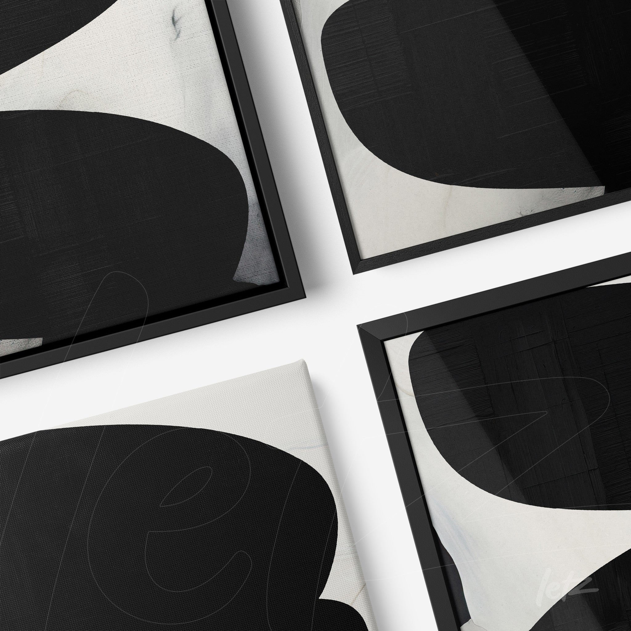 composition of framed wall art featuring abstract black and white shapes with black frames