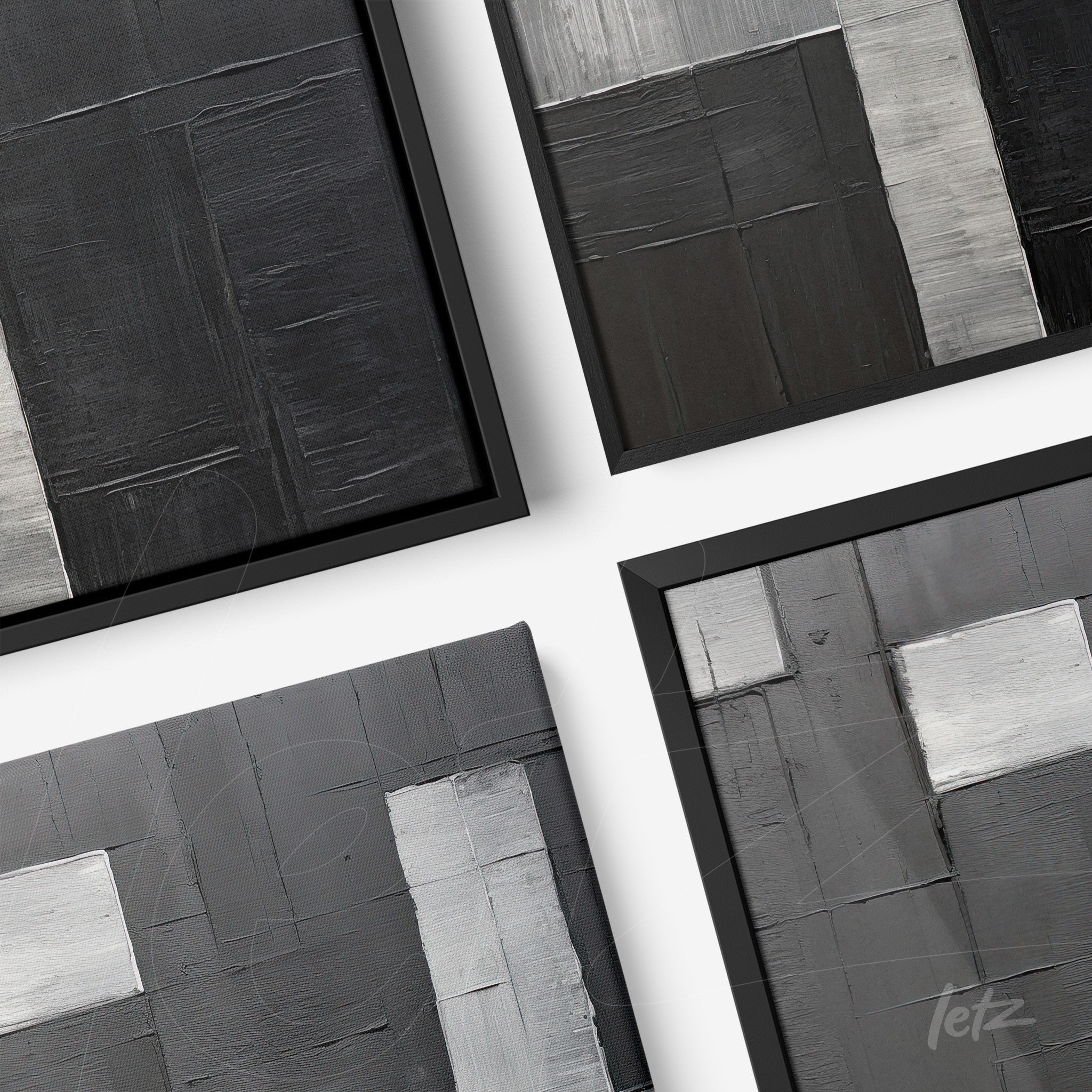 composition of abstract framed artwork in shades of black, gray, and silver with a thin black frame