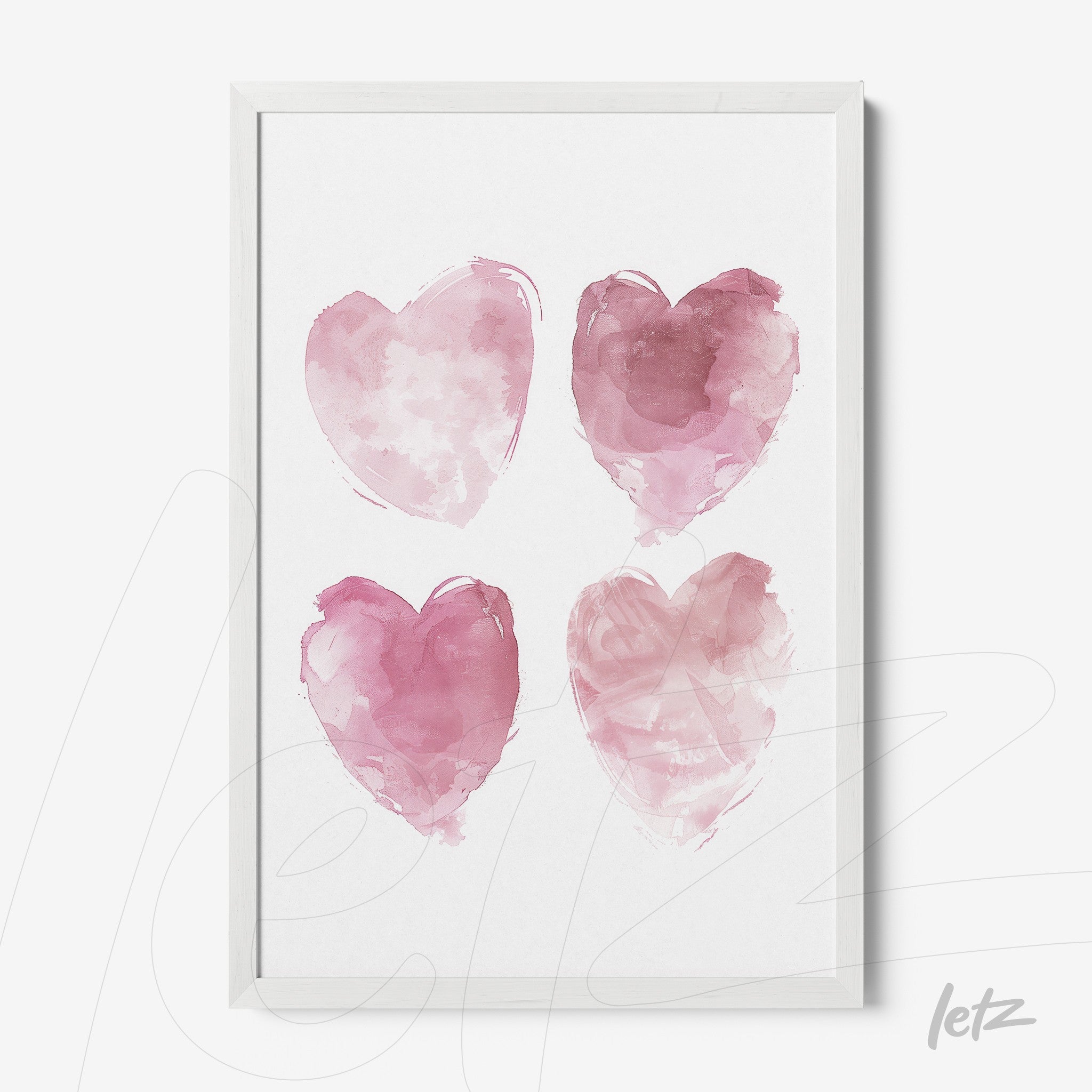 framed artwork featuring four watercolor hearts in shades of pink with a white frame
