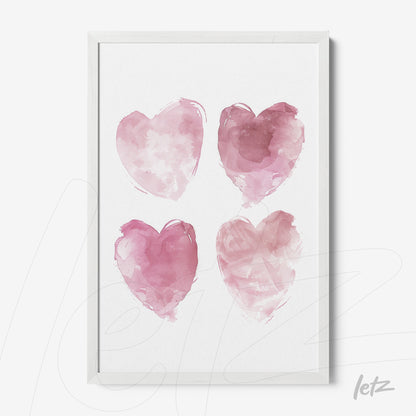 framed artwork featuring four watercolor hearts in shades of pink with a white frame