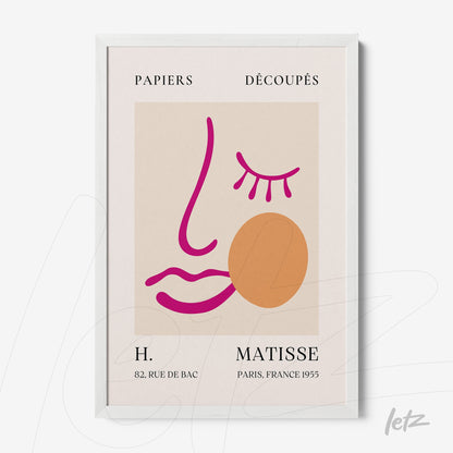 abstract wall art featuring a stylized face on a light beige background with Matisse's signature at the bottom and a white frame