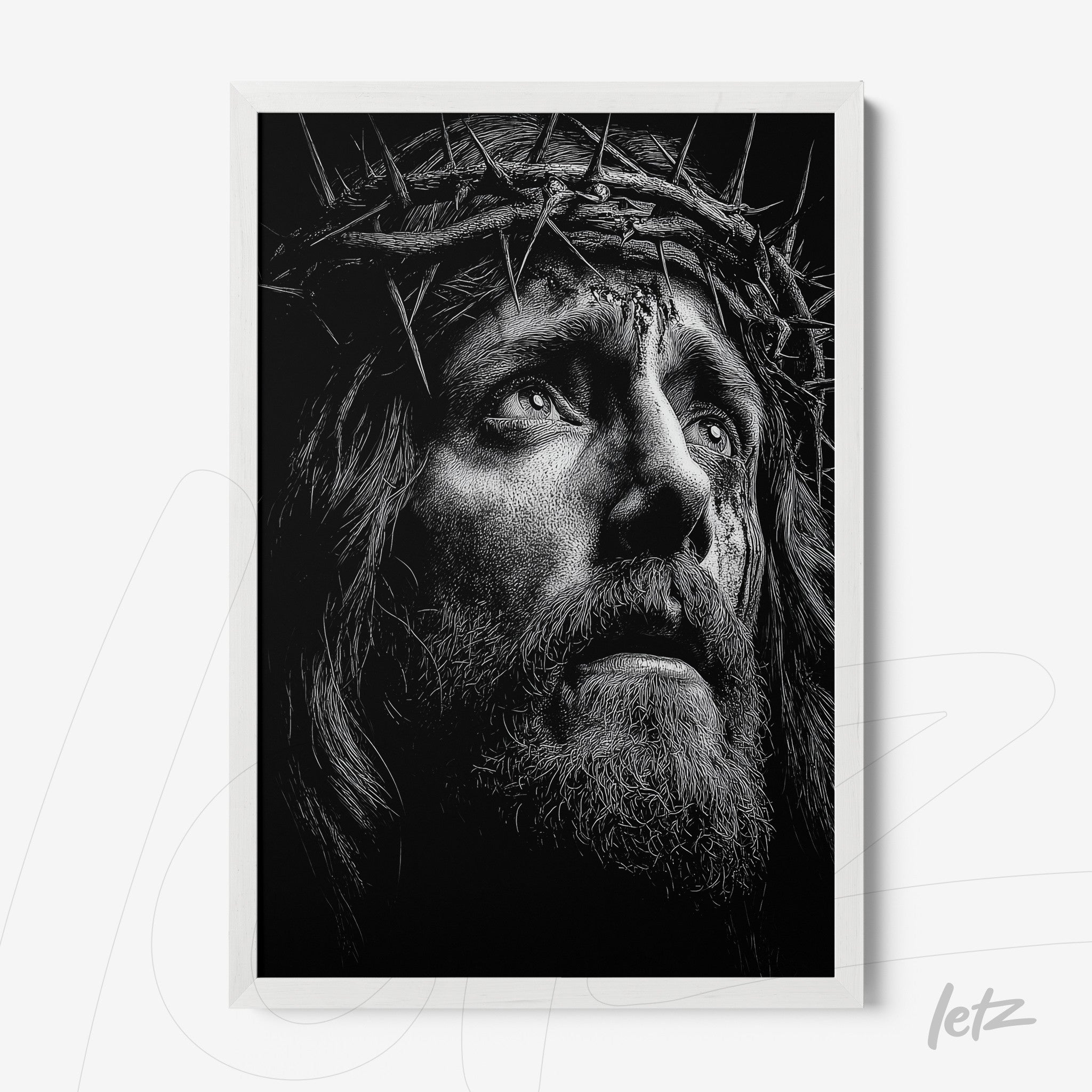 black and white framed artwork depicting the face of Jesus wearing a crown of thorns with a white frame