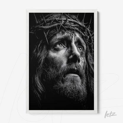 black and white framed artwork depicting the face of Jesus wearing a crown of thorns with a white frame