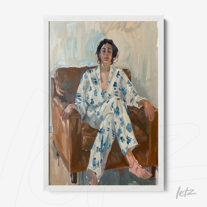 framed artwork of a woman sitting on a brown sofa, wearing white clothing with blue patterns and a neutral toned background