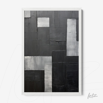 abstract wall art in shades of black and gray with textured relief, framed in white