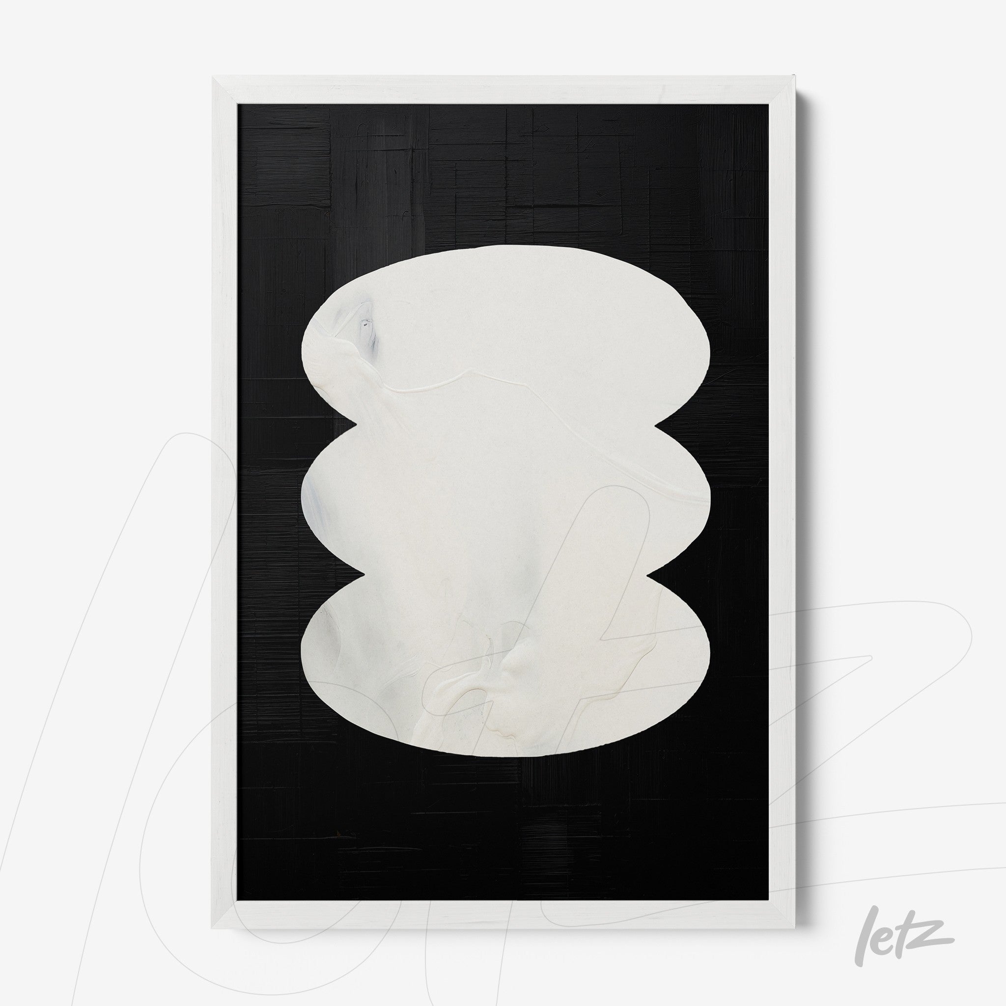 abstract wall art in white frame featuring white oval shapes on textured black background