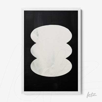abstract wall art in white frame featuring white oval shapes on textured black background