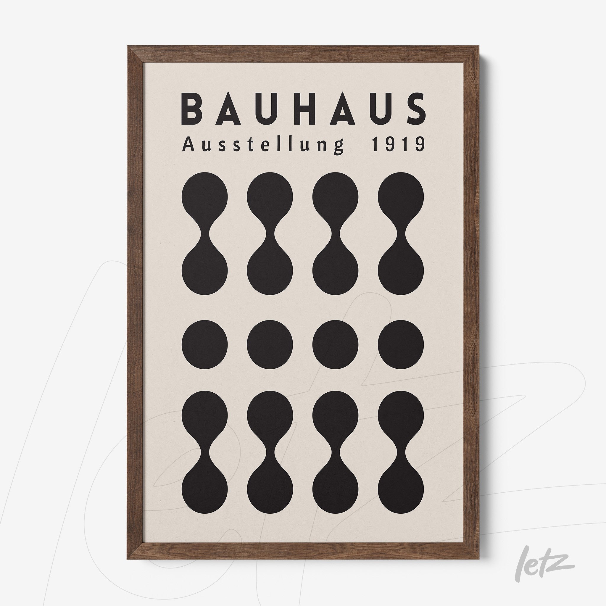 bauhaus poster with black geometric shapes on light background framed in dark wood