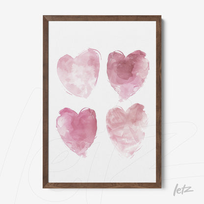 framed artwork featuring four pink watercolor hearts in dark wooden frame