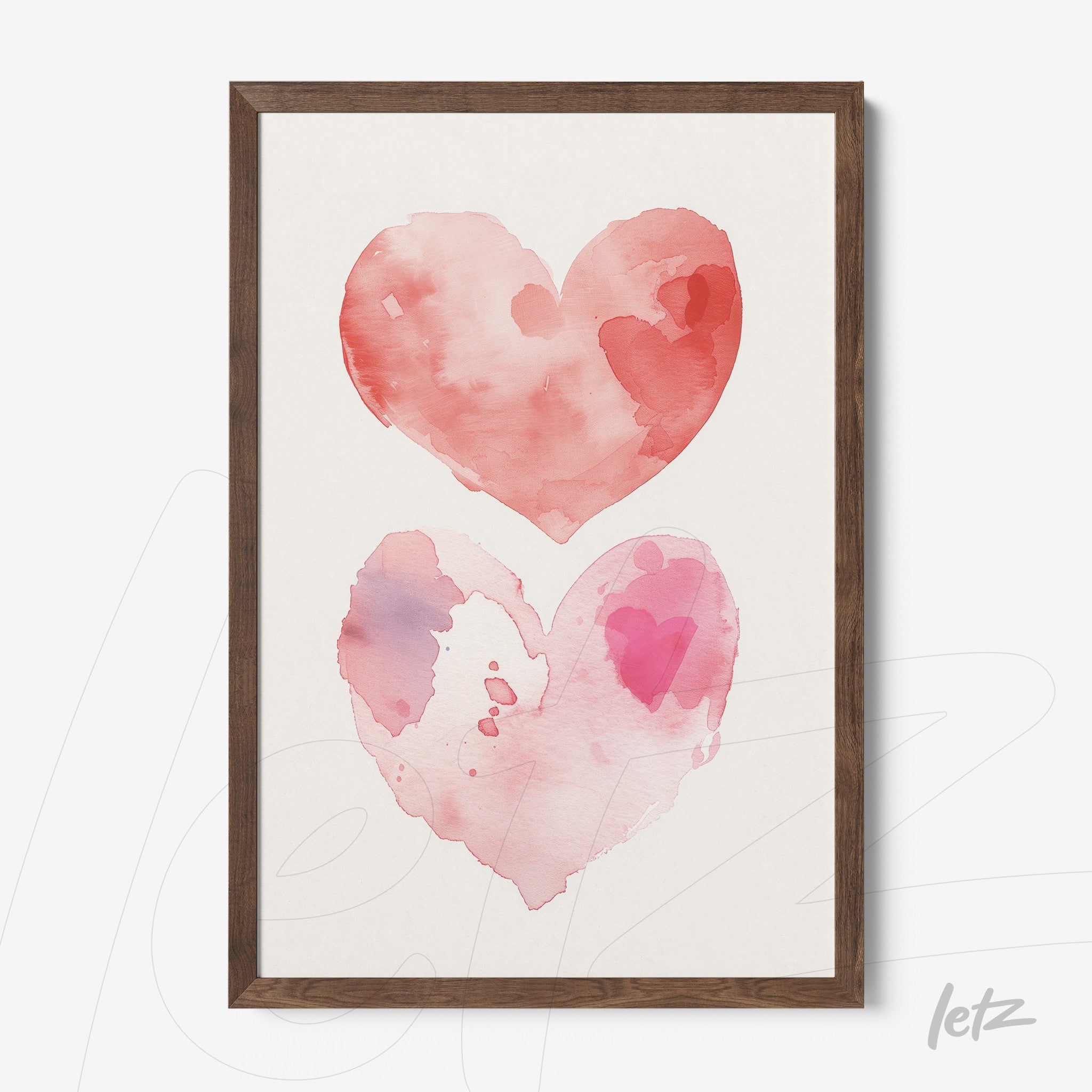 framed artwork featuring two watercolor hearts in shades of red and pink on light background with dark wood frame