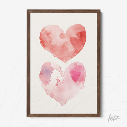 framed artwork featuring two watercolor hearts in shades of red and pink on light background with dark wood frame
