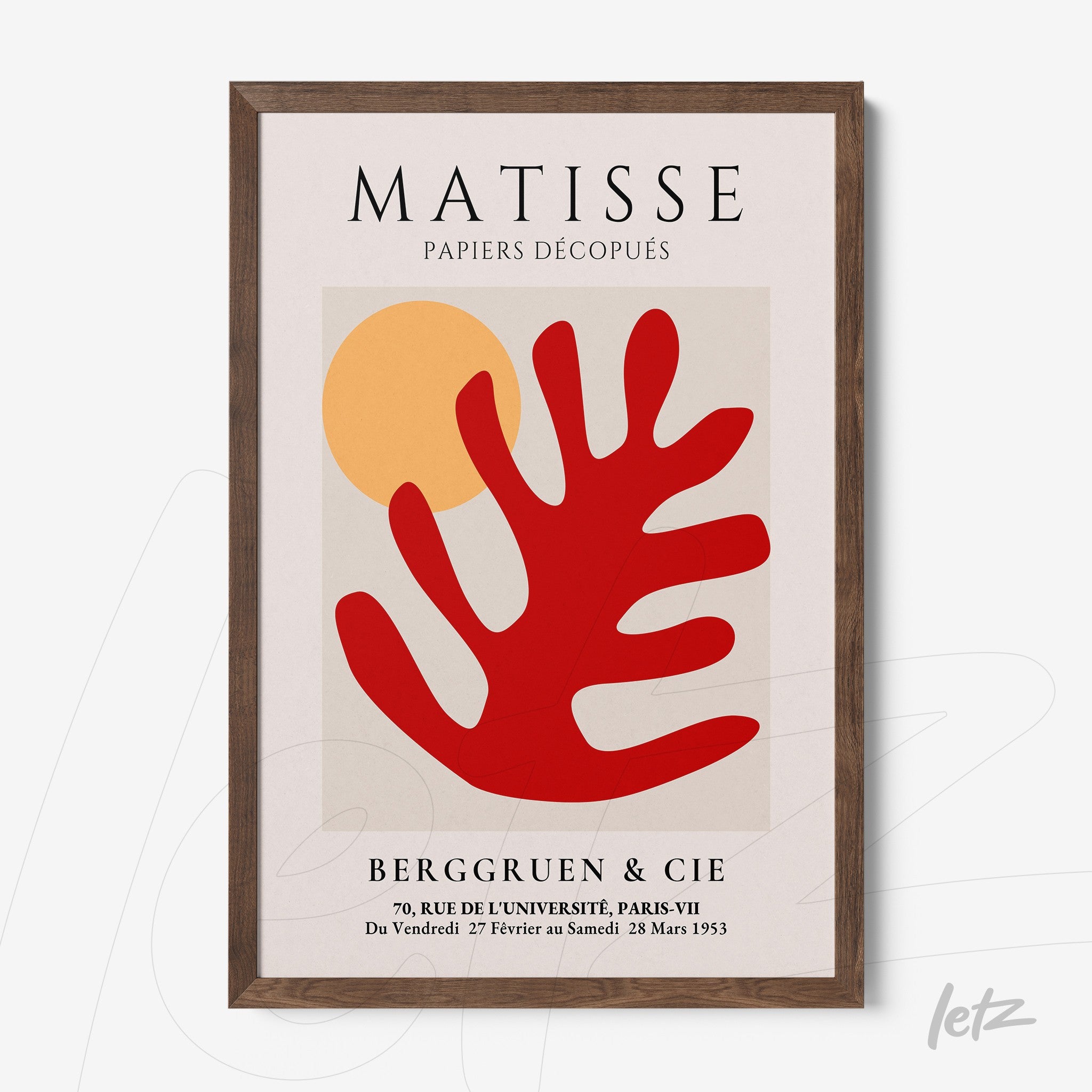 framed wall art featuring modern stylized leaves in red against a light background with a dark wood frame