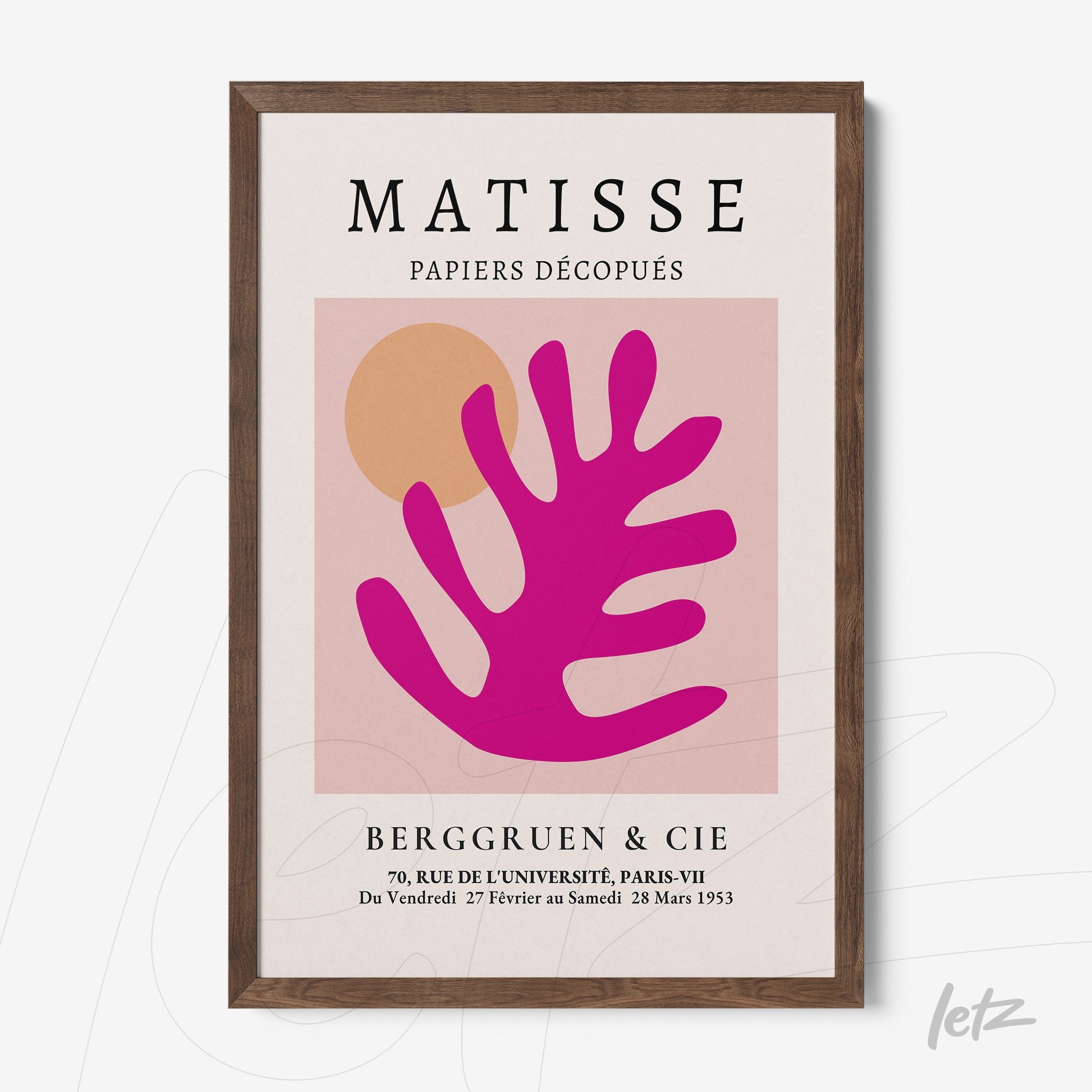 framed modern art print featuring colorful cutouts in pink and orange with a dark wood frame